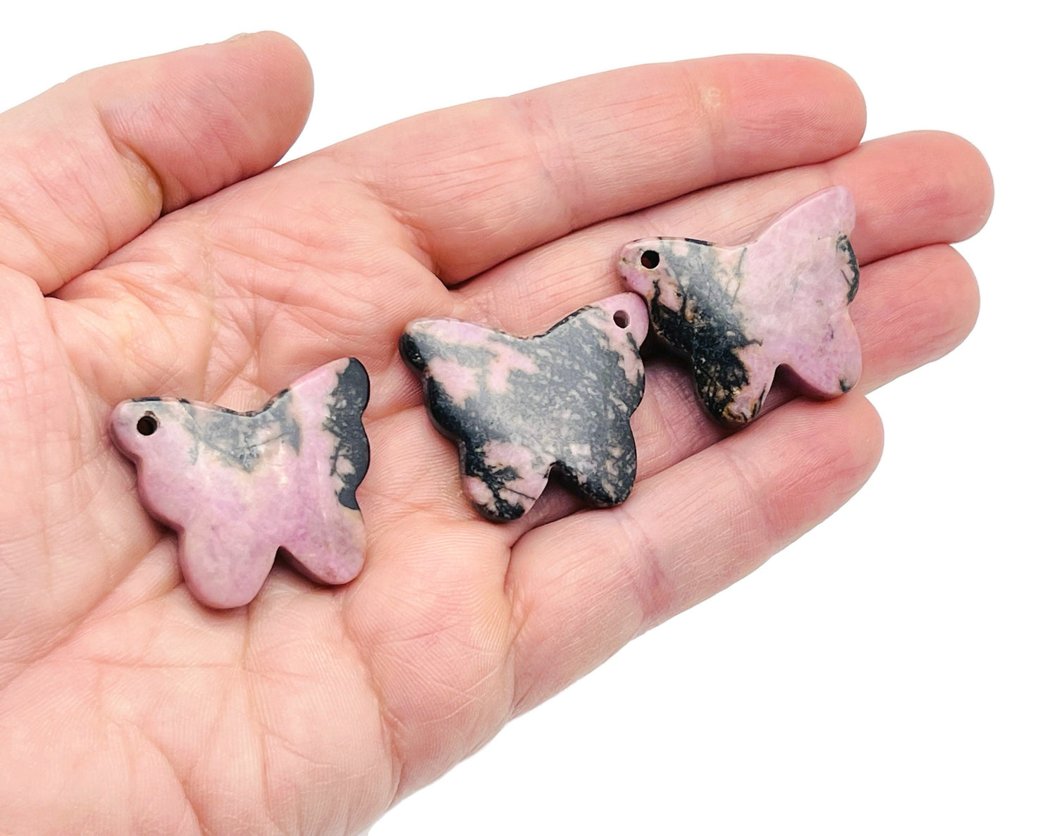 Rhodonite butterfly gemstone pendant with hole for jewelry, showcasing vibrant pink and black patterns, crafted by GemstoneGO.