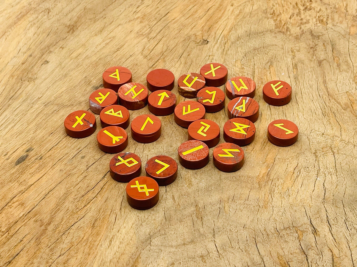 Red Jasper crystal rune stones set with Elder Futhark engravings, 25 pieces, gemstone kit for divination and spiritual practices.