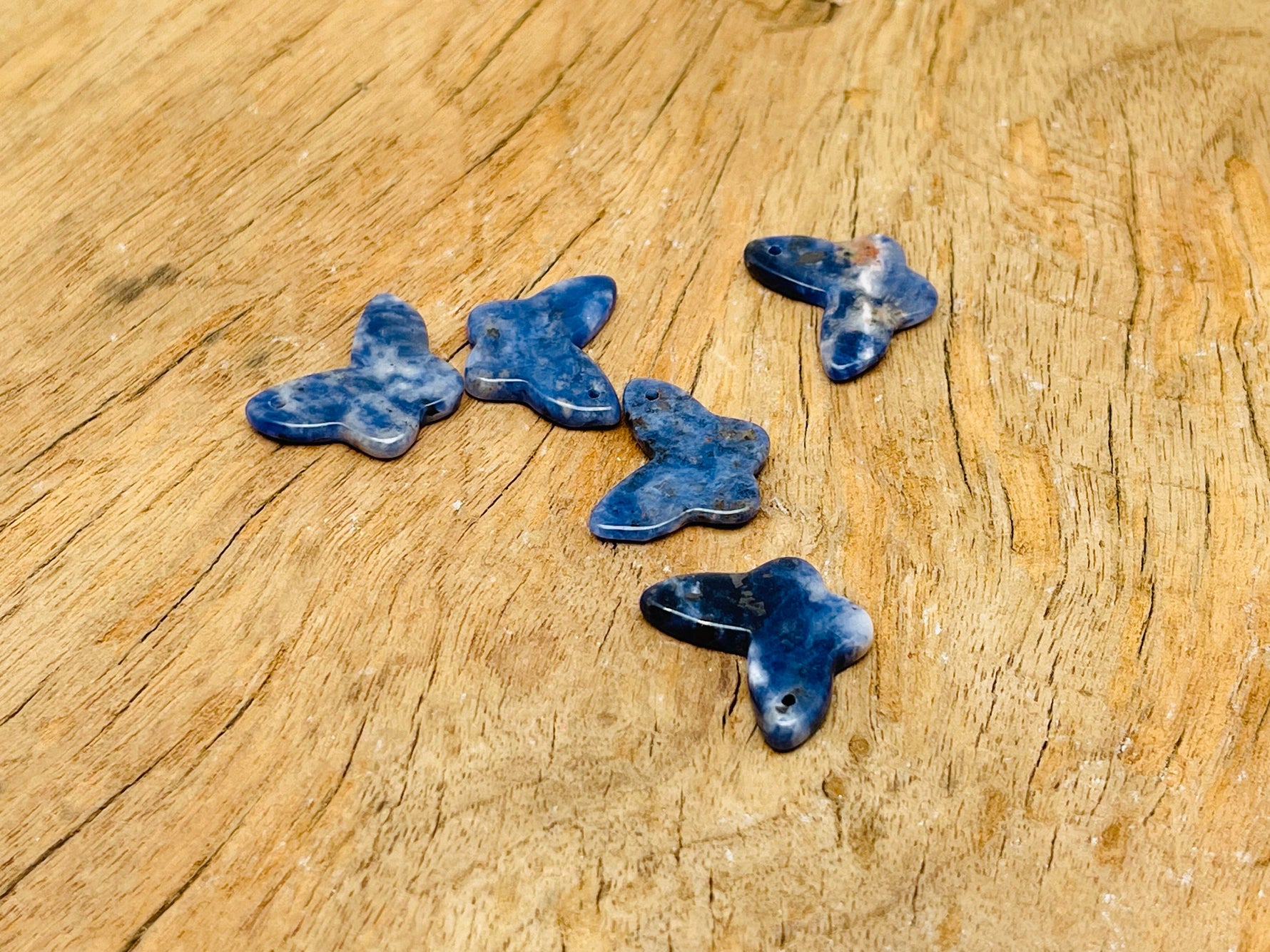 Sodalite mini butterfly gemstone pendant from GemstoneGO, featuring a hole crystal design in blue and white gemstone.