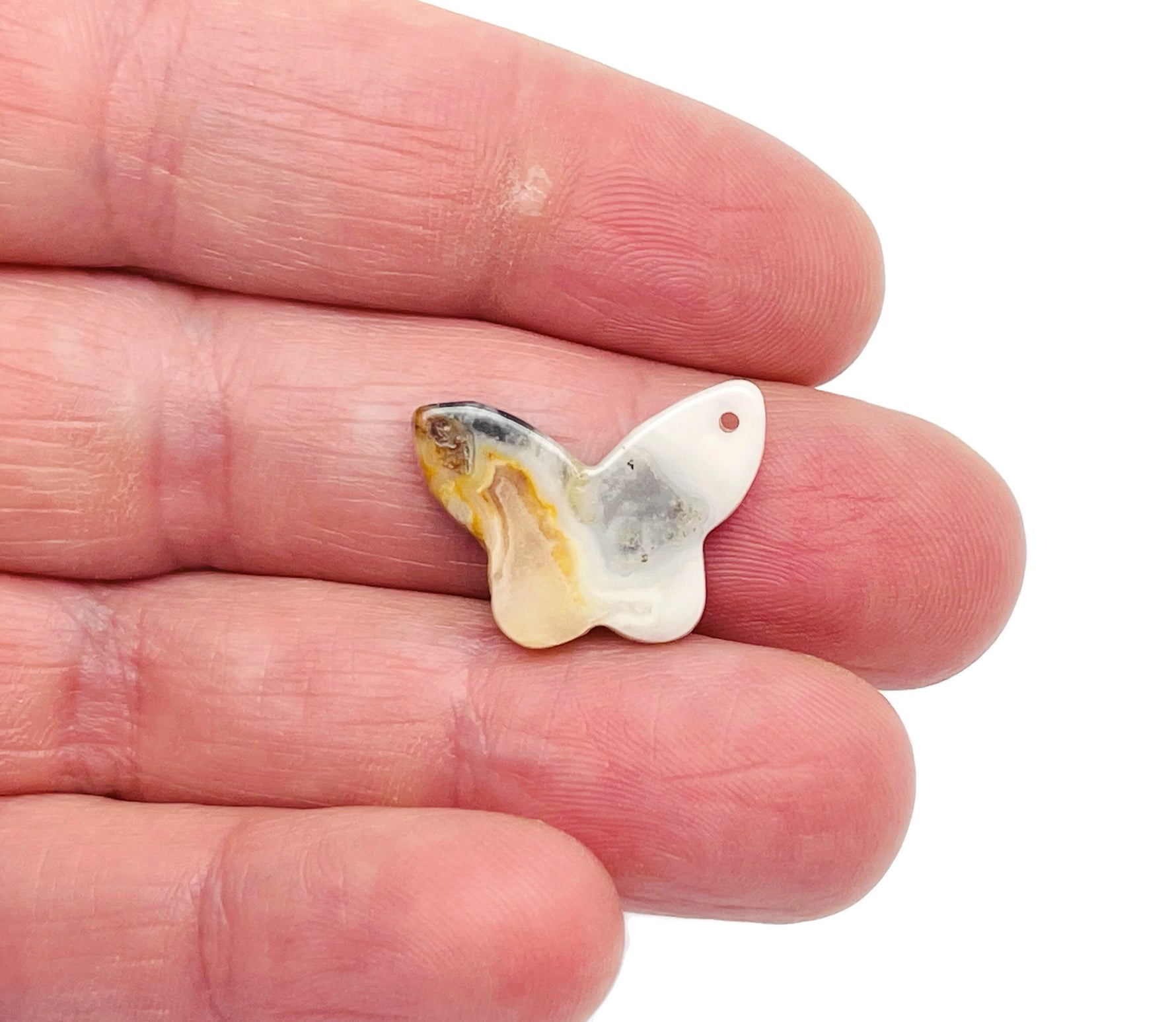 Mini butterfly gemstone pendant made from Crazy Lace Agate with hole for jewelry, showcasing vibrant, colorful crystal gemstone.