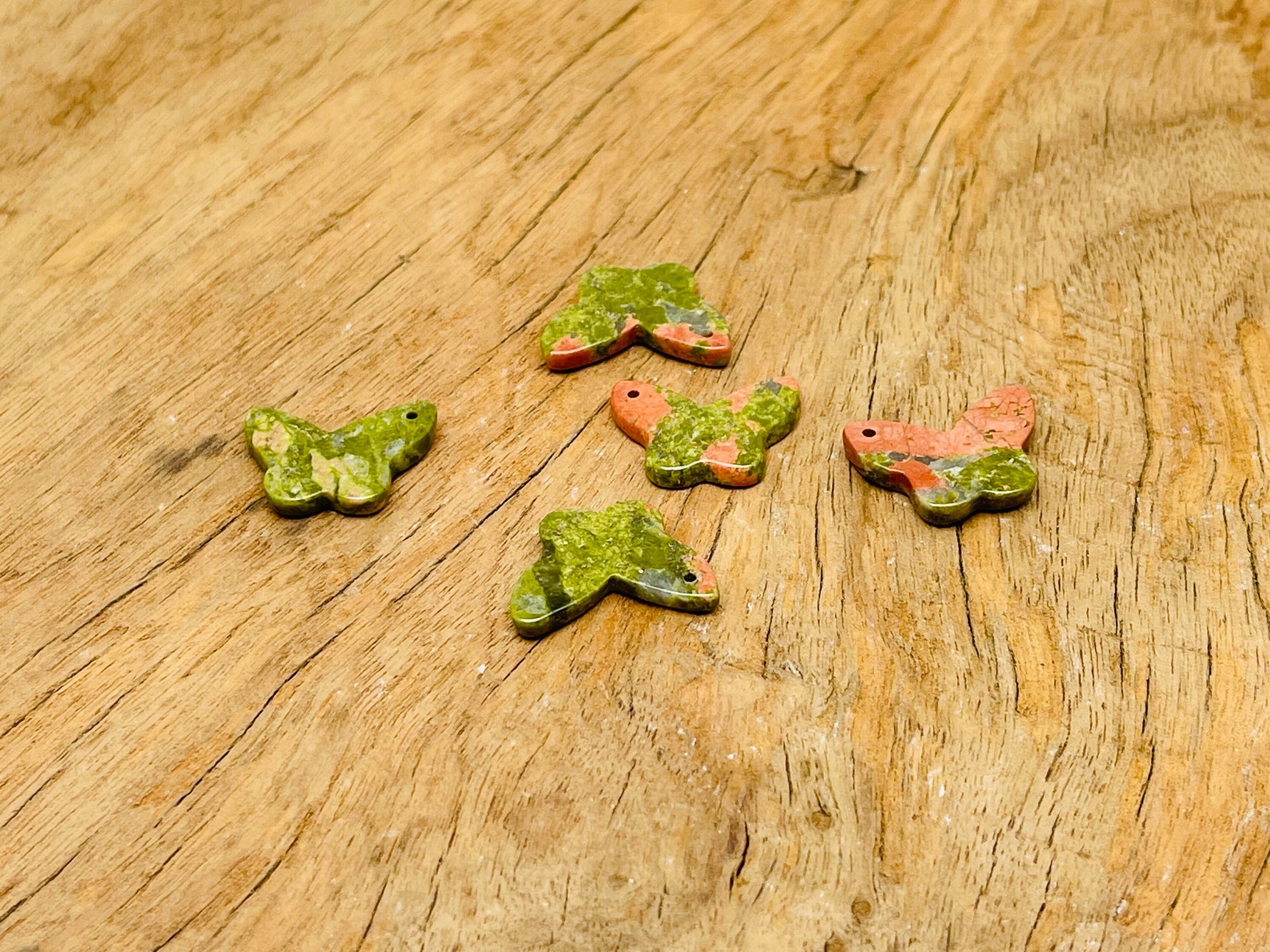 Unakite mini butterfly gemstone pendant with hole for jewelry, featuring vibrant green and pink hues, by GemstoneGO.