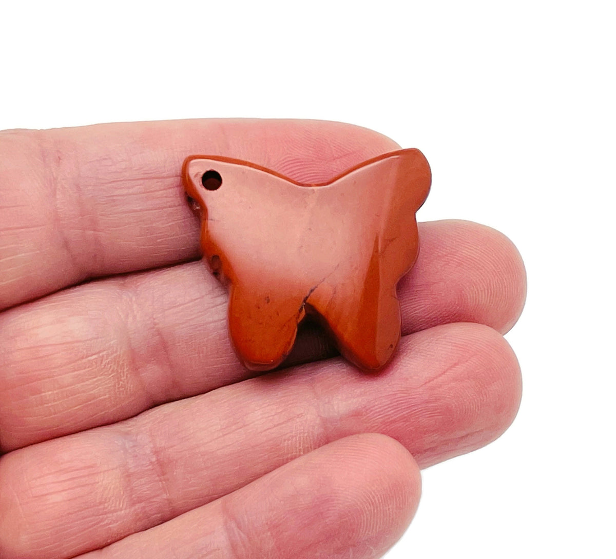 Red Jasper butterfly gemstone pendant with hole crystal jewelry from GemstoneGO, showing a vibrant red Jasper butterfly charm.