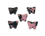 Rhodonite butterfly gemstone pendant with a hole for jewelry, featuring vibrant pink and black stone details, handcrafted by GemstoneGO.