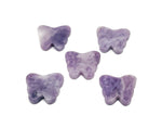 Lepidolite butterfly gemstone pendant with hole for jewelry, showcasing purple and lavender hues in a close-up shot.