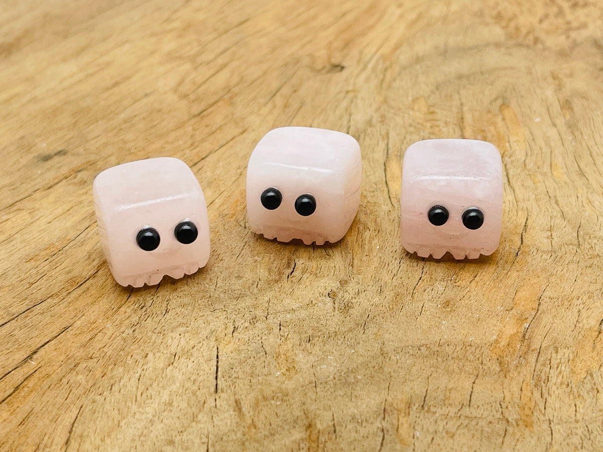 Handmade rose quartz gemstone carving skull from GemstoneGO, showcasing detailed craftsmanship and smooth, polished surface.