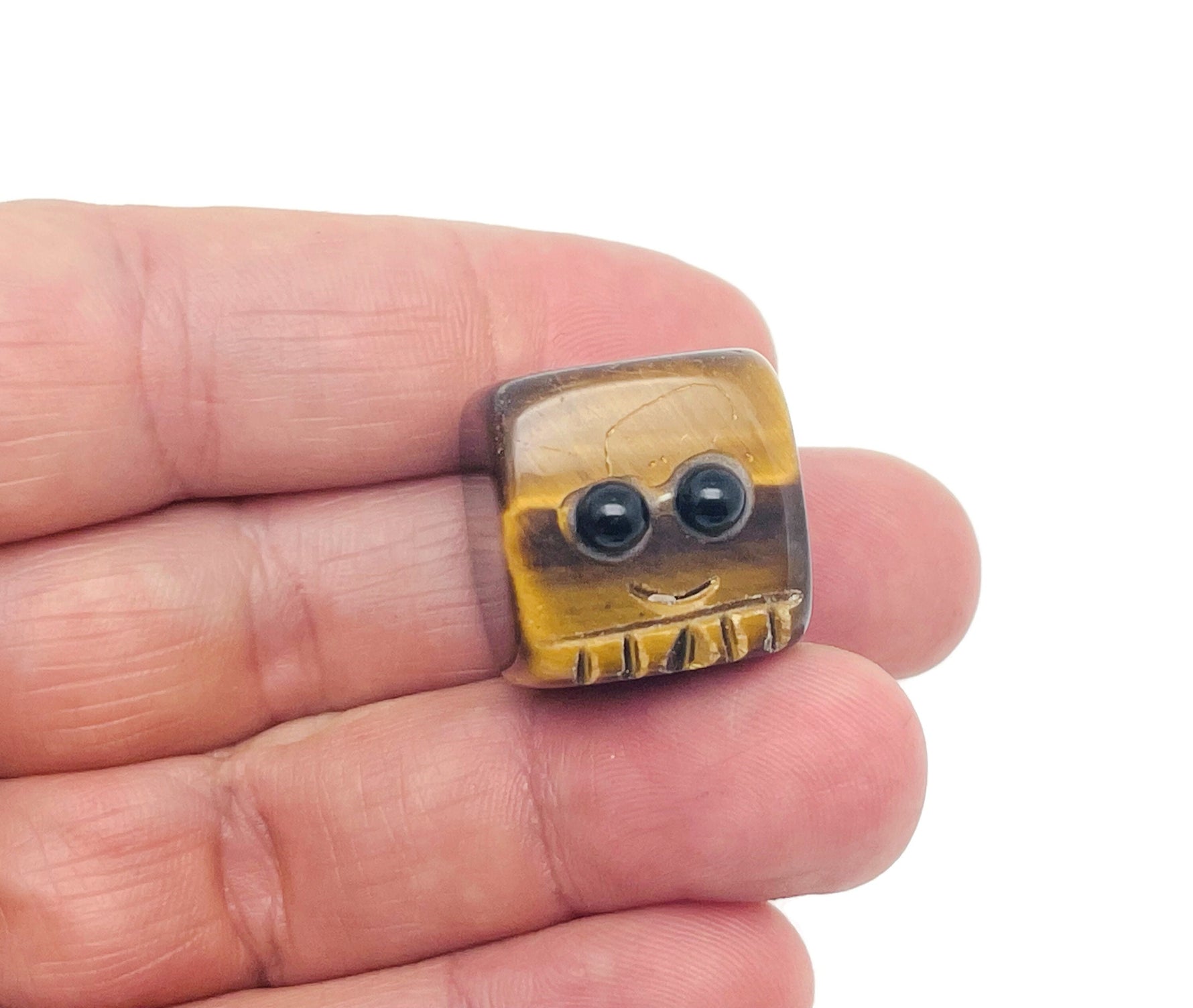 Tiger Eye handmade carving skull gemstone by GemstoneGO, detailed crystal sculpture for collectors and gift-giving.