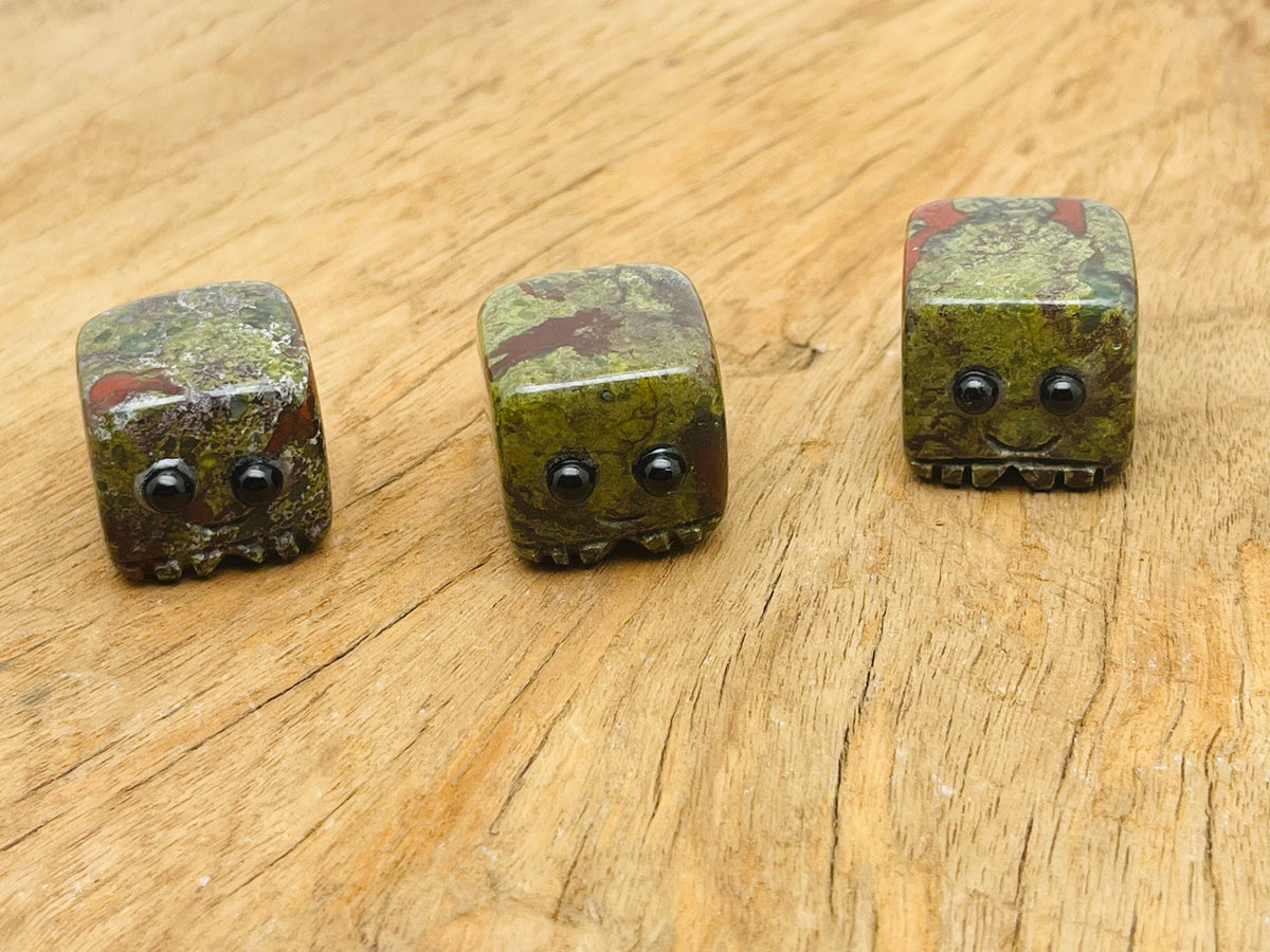 Handmade Dragon Blood Jasper skull gemstone carving from GemstoneGO, showcasing detailed craftsmanship and vibrant red hues.