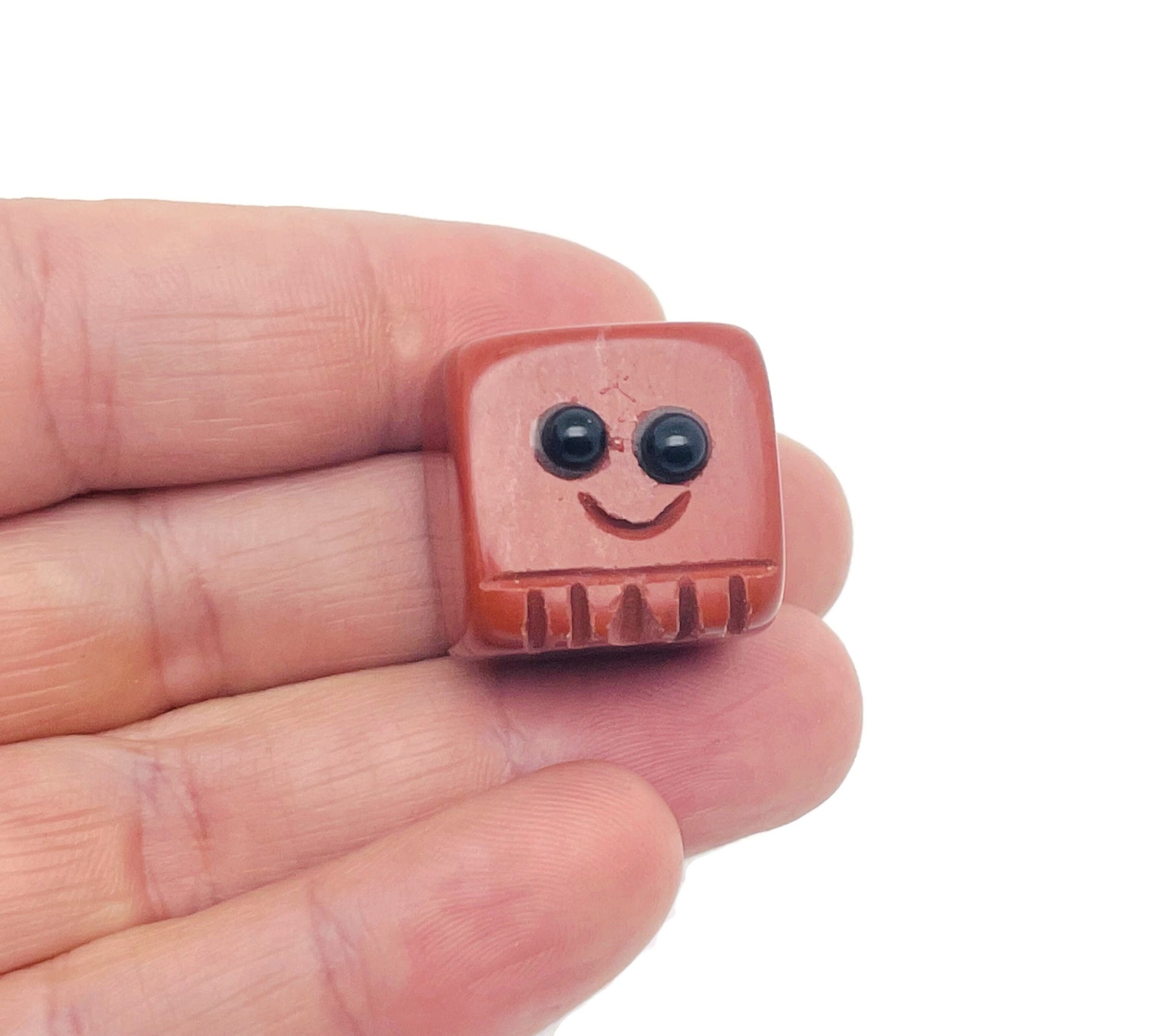 Red Jasper carved skull gemstone from GemstoneGO, showcasing detailed handmade craftsmanship and vibrant red color.
