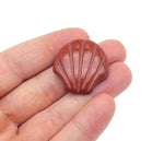 Red Jasper sea shell carving gemstone, 30mm, from GemstoneGO, showing intricate shell design and vibrant red color.
