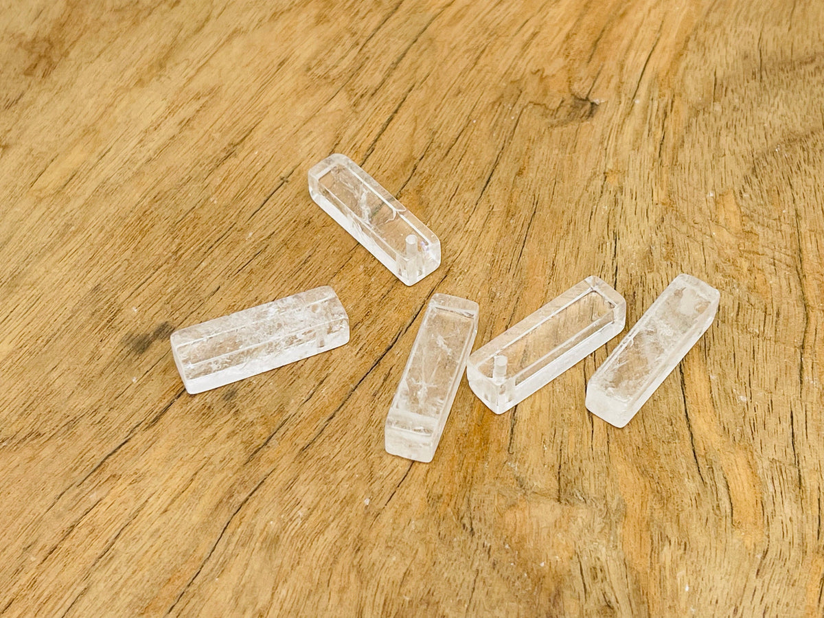 Clear quartz crystal pendant from GemstoneGO, drilled gemstone for jewelry making, showcasing a polished, transparent mineral pendant.