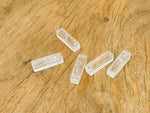 Clear quartz crystal pendant from GemstoneGO, drilled gemstone for jewelry making, showcasing a polished, transparent mineral pendant.