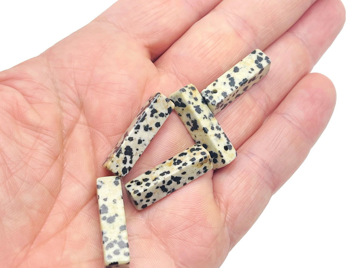 Dalmatian Jasper crystal pendant with drilled hole, showcasing black spots on cream stone, ideal for jewelry making by GemstoneGO.