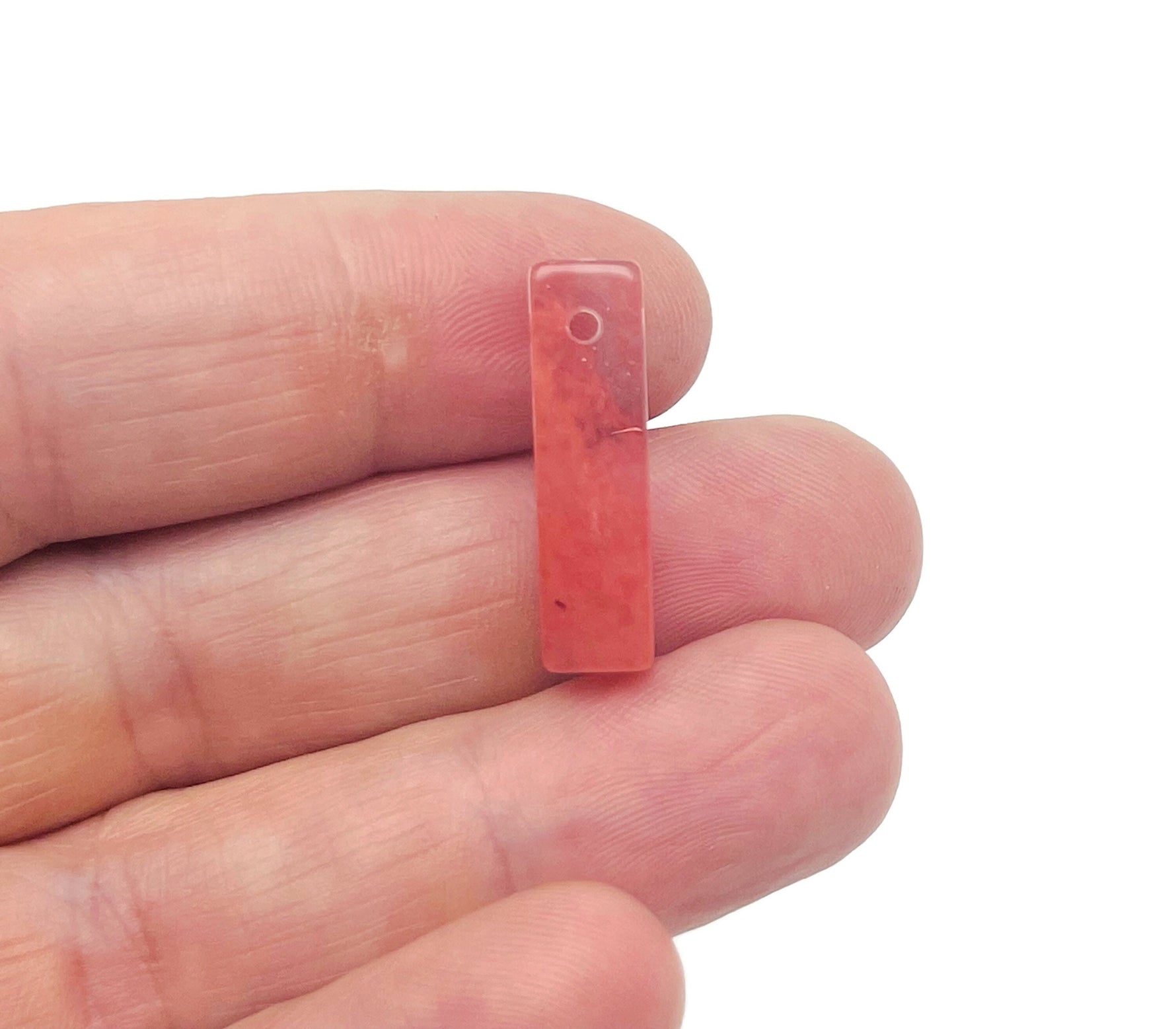 Cherry quartz crystal pendant from GemstoneGO, drilled gemstone for jewelry making, showcasing vibrant red color and smooth polished surface.