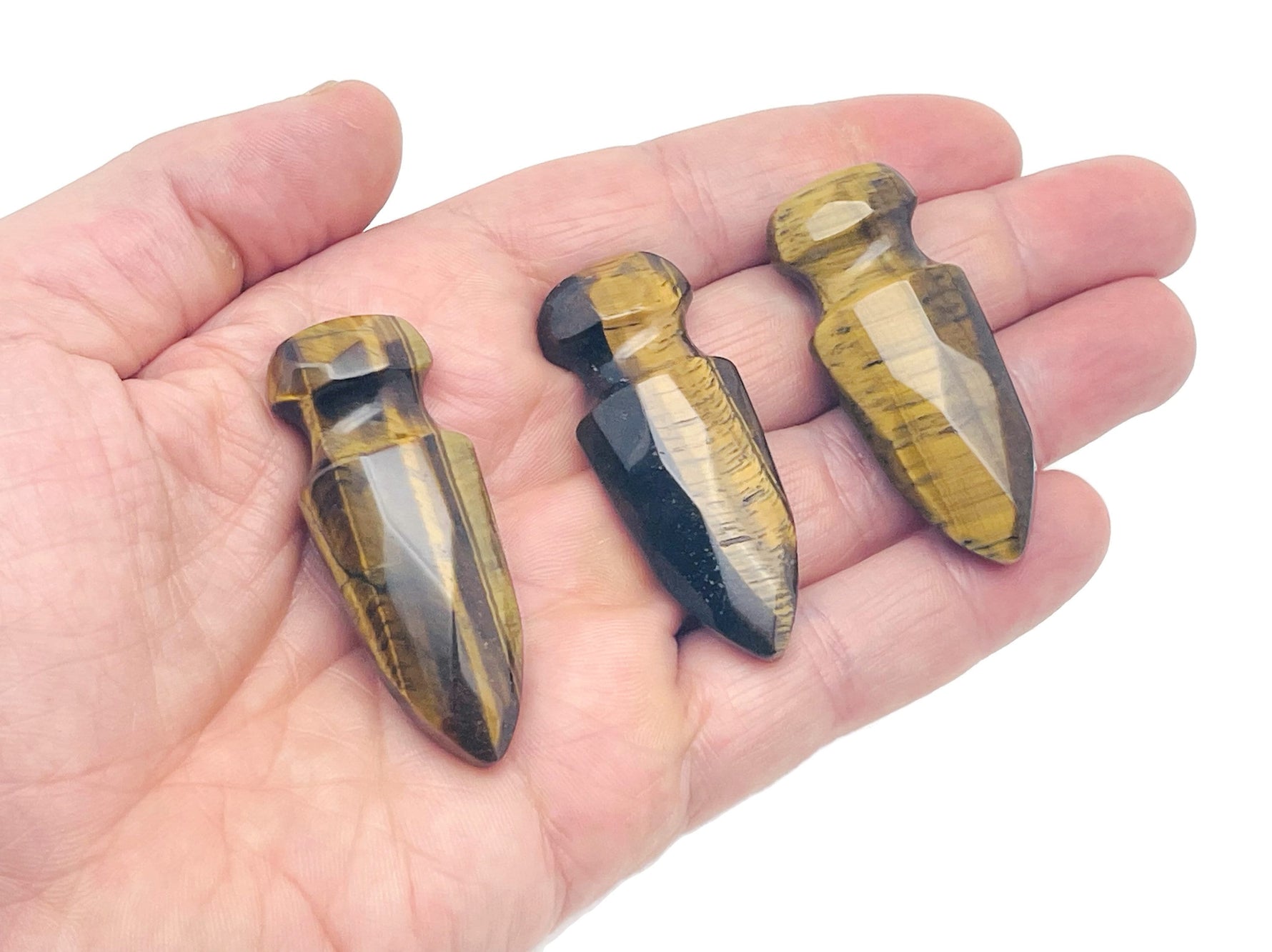 Carved Tiger Eye gemstone sword dagger pendant, 50mm, detailed craftsmanship by GemstoneGO displayed in the image.