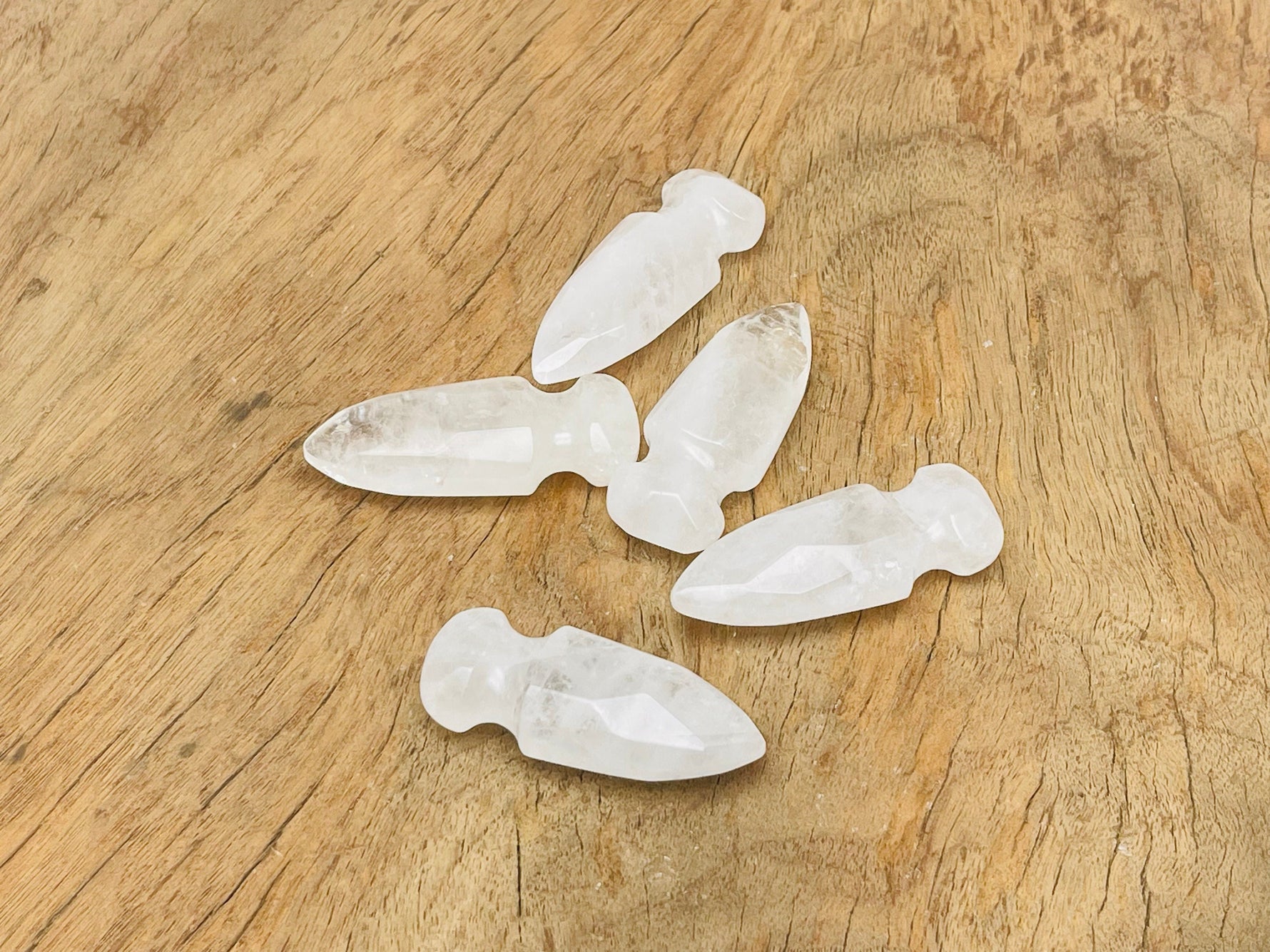 Clear quartz sword dagger carved gemstone, 50mm, from GemstoneGO, showcasing intricate carvings and a polished, transparent appearance.