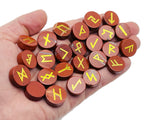 Red Jasper crystal rune stones set with Elder Futhark engravings, 25-piece gemstone kit for divination and spiritual practices.
