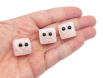Handmade rose quartz skull gemstone carving with detailed features, perfect as a crystal gift or decorative piece.