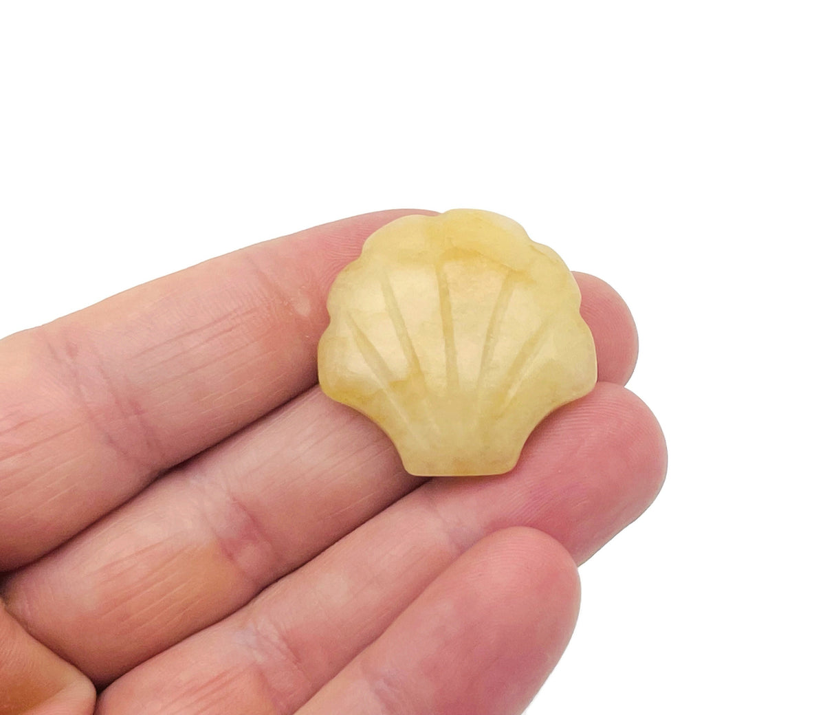 Yellow jade sea shell carving gemstone, 30mm, from GemstoneGO, showcasing intricate shell and jade details.
