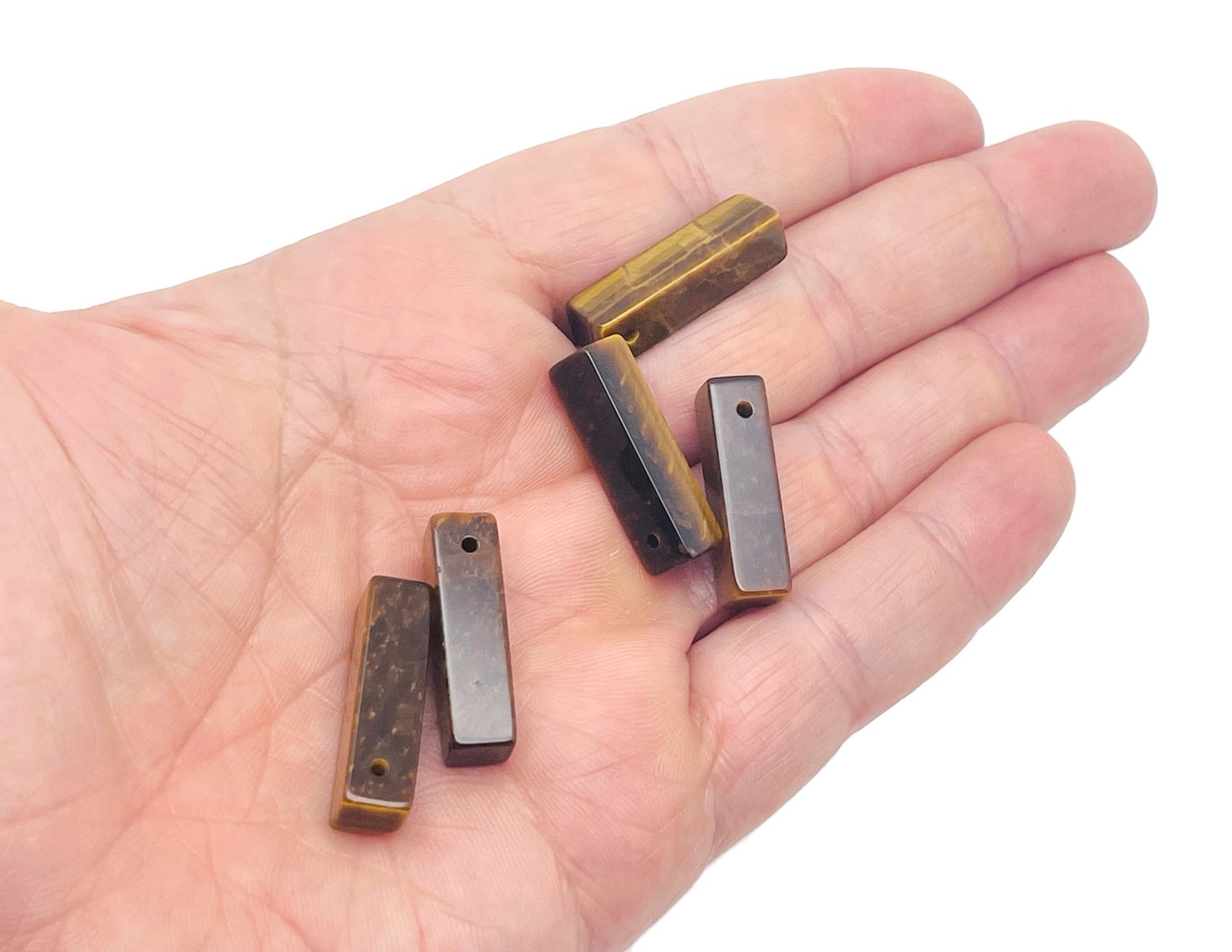 Tiger Eye crystal pendant from GemstoneGO, drilled gemstone for jewelry making, showcasing the polished, golden-brown stone.