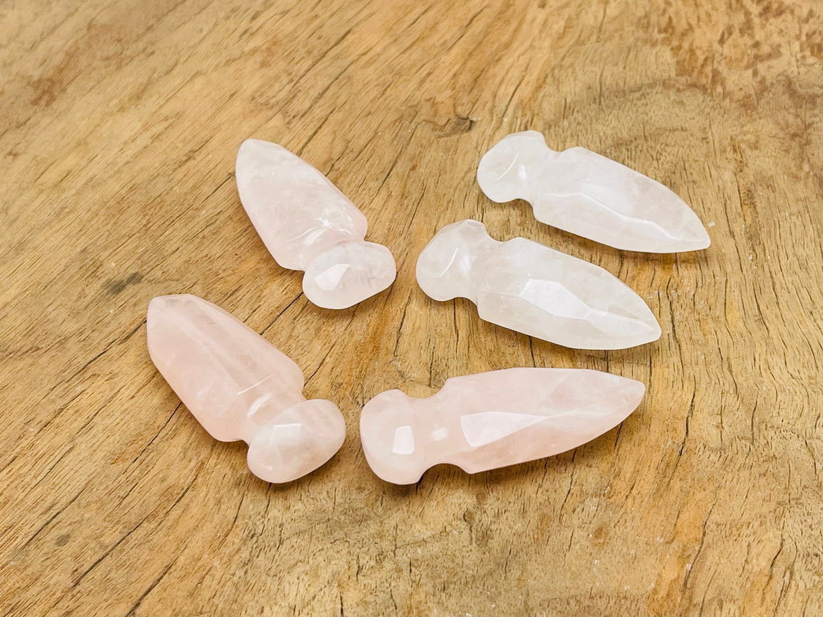 Carved rose quartz sword dagger gemstone, 50mm, with intricate details, from GemstoneGO, showcasing its polished, vibrant pink color.