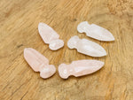 Carved rose quartz sword dagger gemstone, 50mm, with intricate details, from GemstoneGO, showcasing its polished, vibrant pink color.