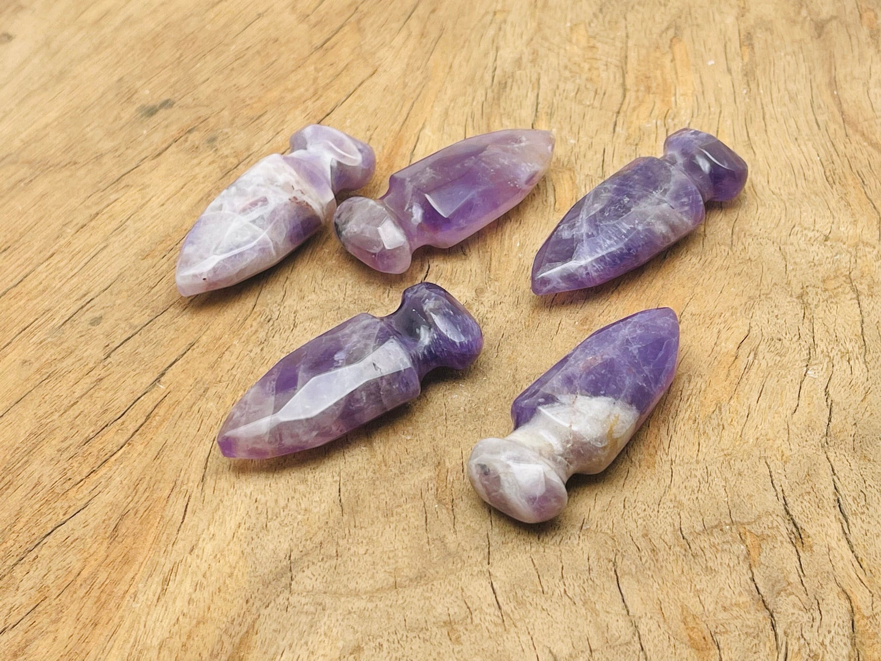 Carved amethyst gemstone sword dagger measuring 50mm, featuring intricate details and natural purple hues, from GemstoneGO.