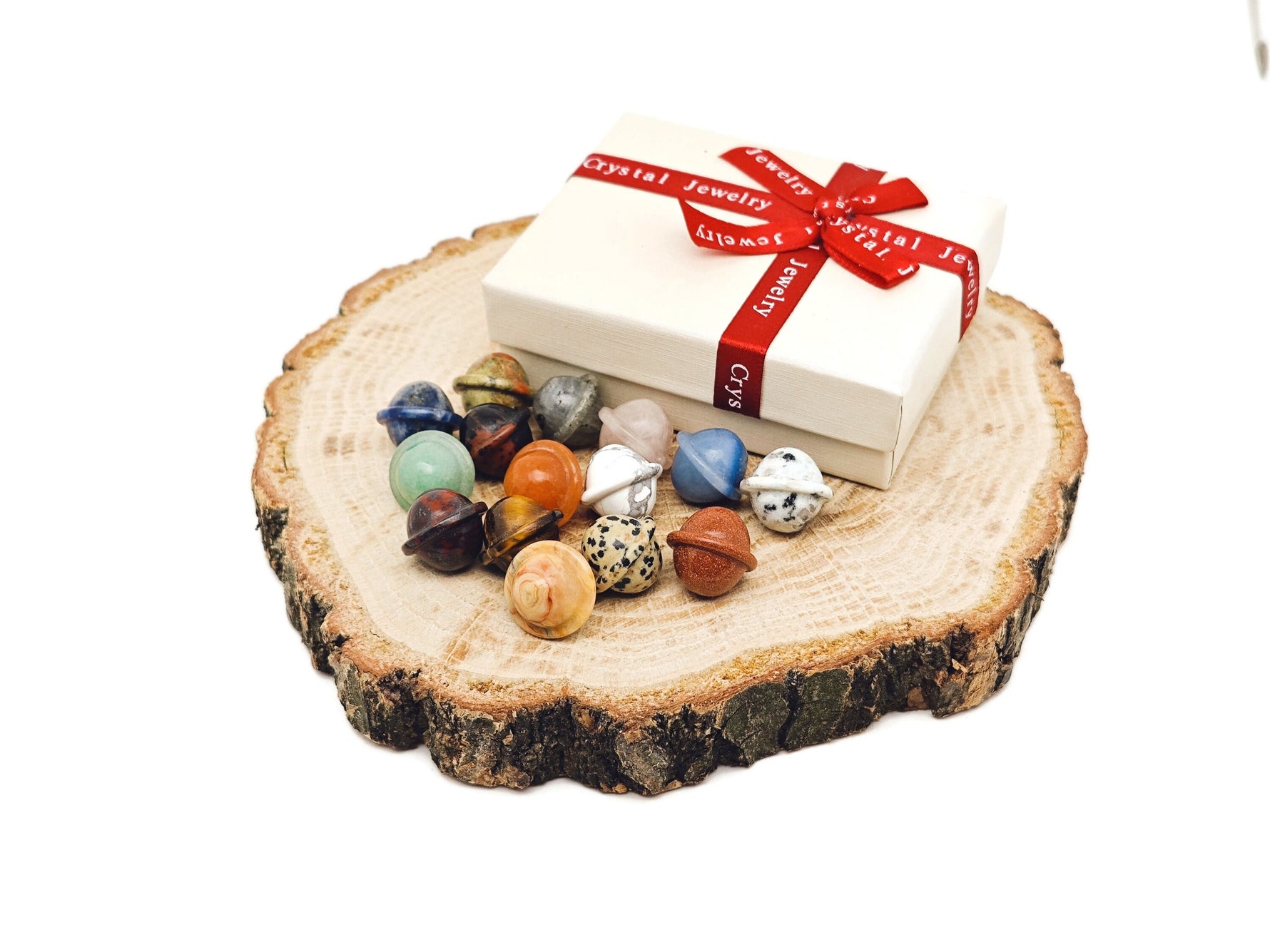 Set of 10 assorted gemstones from GemstoneGO's Crystal Mystery Box Gift featuring Saturn carving and colorful crystals.