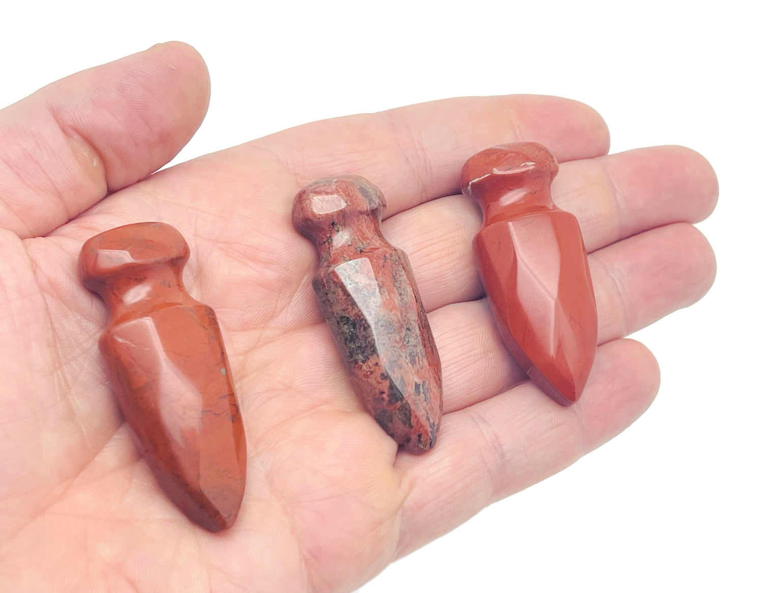 Red Jasper sword-shaped dagger carved gemstone, 50mm, with detailed carvings and natural red stone coloration.