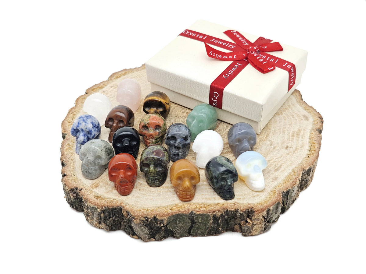 Seven assorted gemstones in a crystal mystery box gift featuring a carved skull design from GemstoneGO.