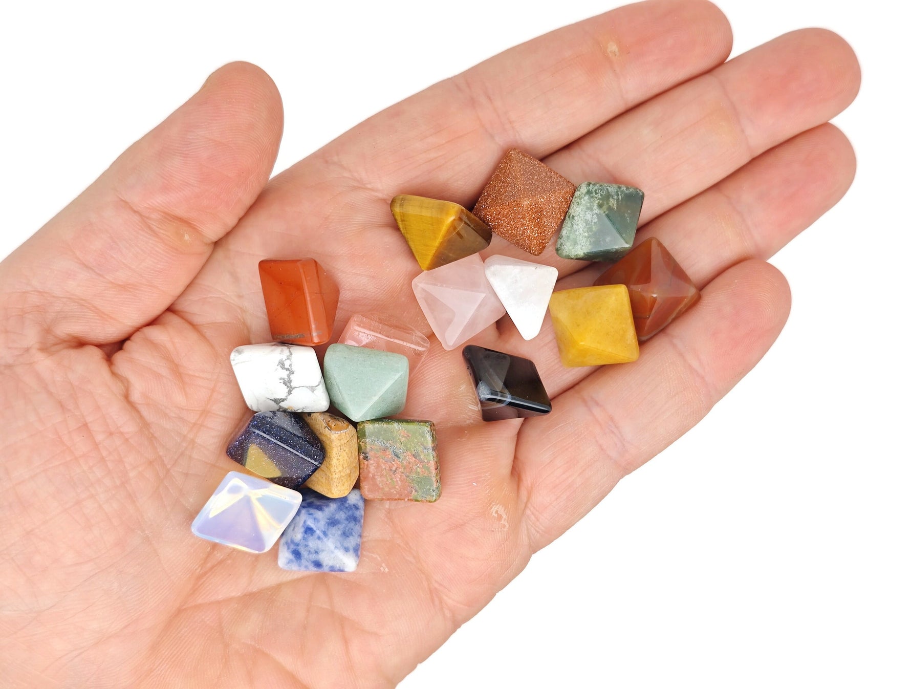 Assorted gemstones in a pyramid shape from GemstoneGO's Crystal Mystery Box Gift Kit, featuring 10 randomly selected crystals.