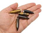 Polished tiger eye bullet gemstone pendant with carved details, showcasing warm brown and gold hues, from GemstoneGO.