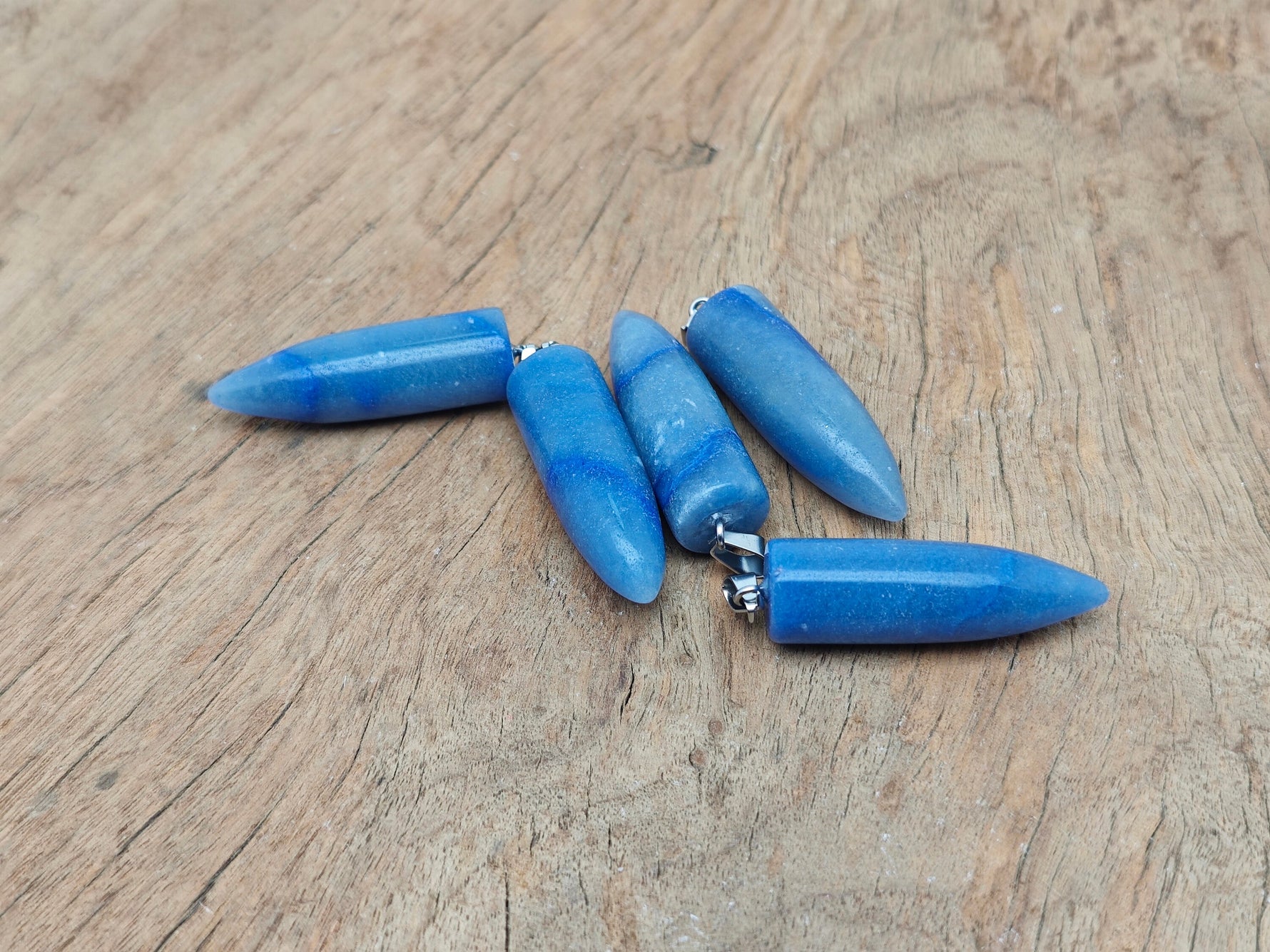 Blue aventurine bullet gemstone pendant with polished carved design, featuring a smooth, rounded shape and natural gemstone texture.