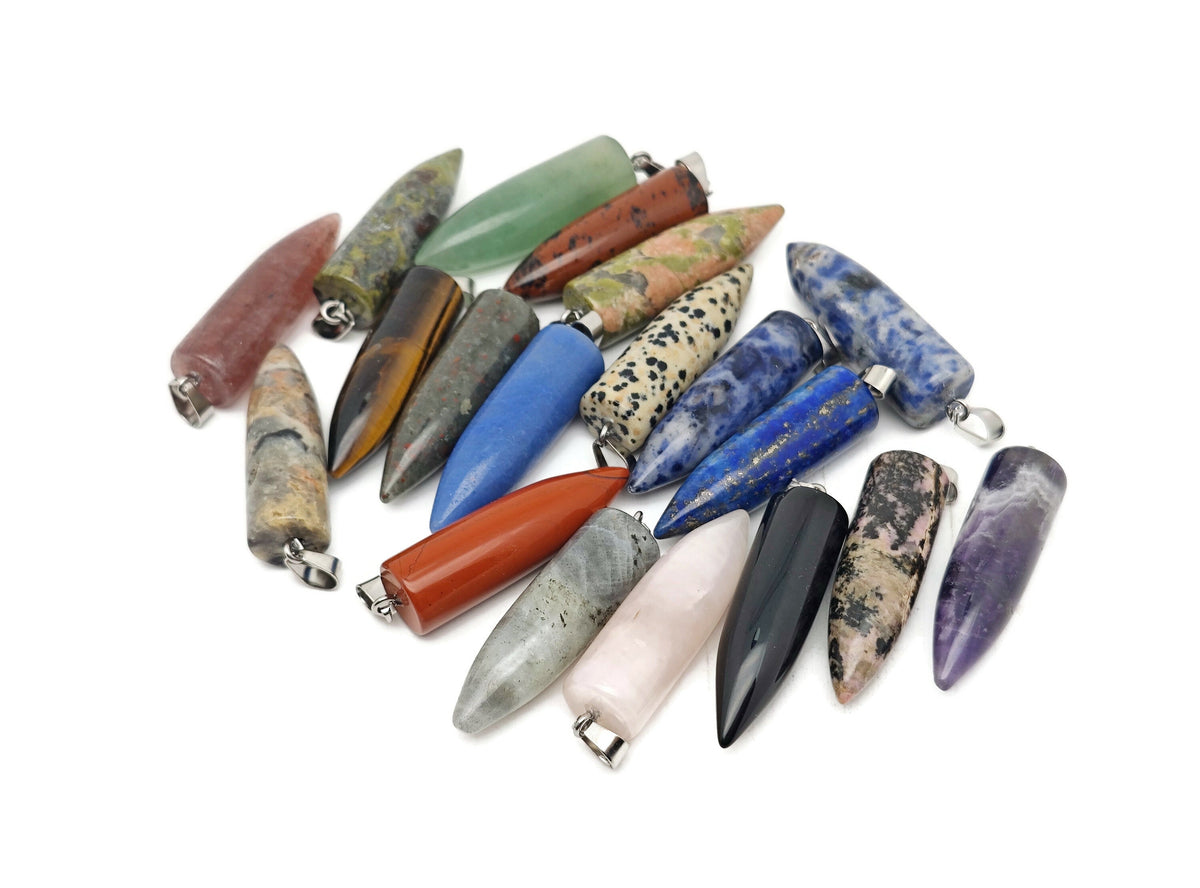 Polished gemstone bullet pendant with carved crystal healing mineral design, featuring vibrant colors and intricate details.