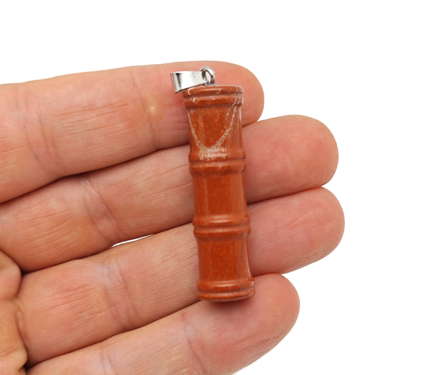 Red Jasper bamboo-shaped crystal pendant from GemstoneGO, featuring a protective crystal design and vibrant red jasper stone.