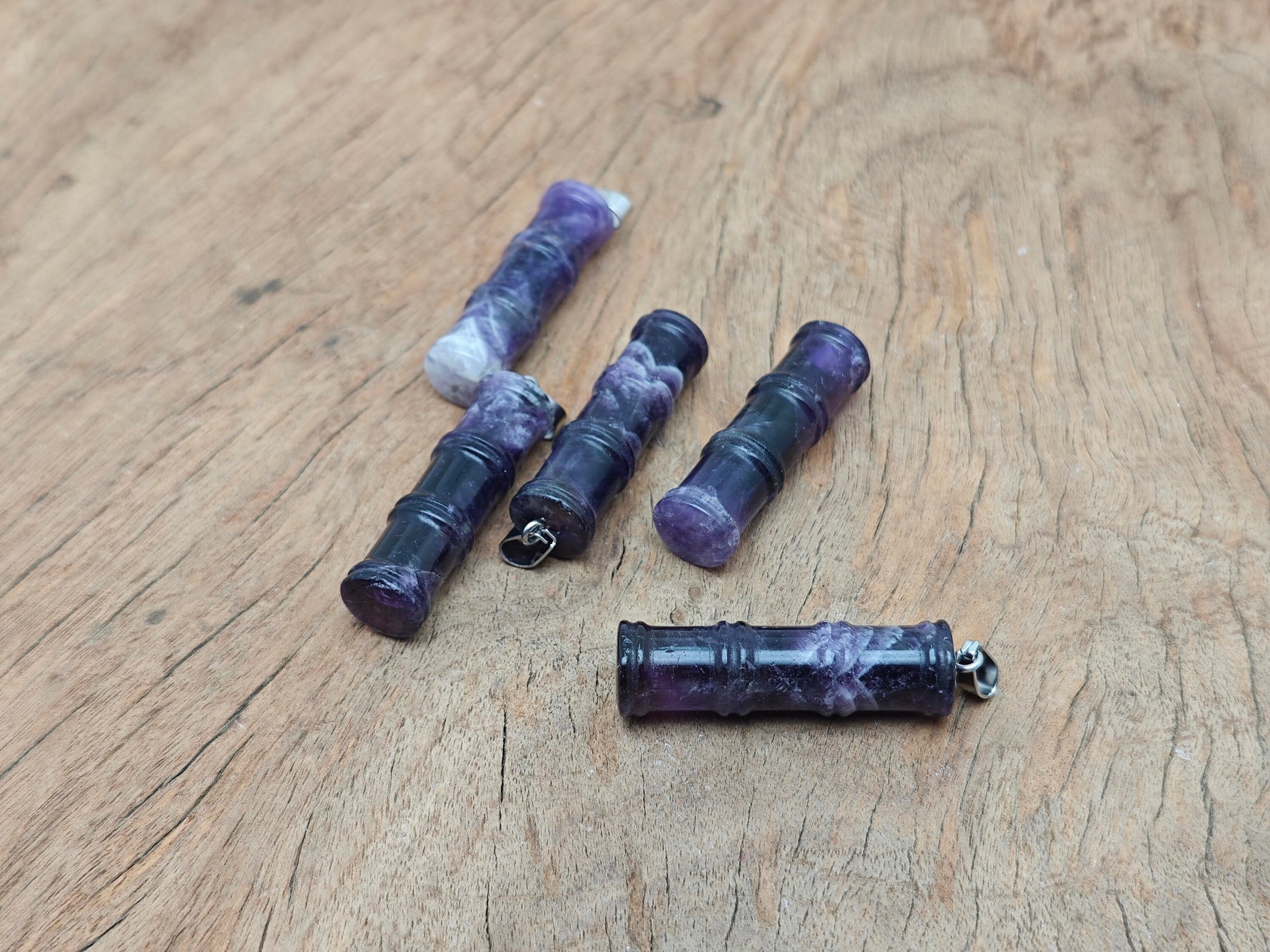 Amethyst bamboo-shaped crystal pendant from GemstoneGO, featuring a protective amethyst gemstone with intricate bamboo design.
