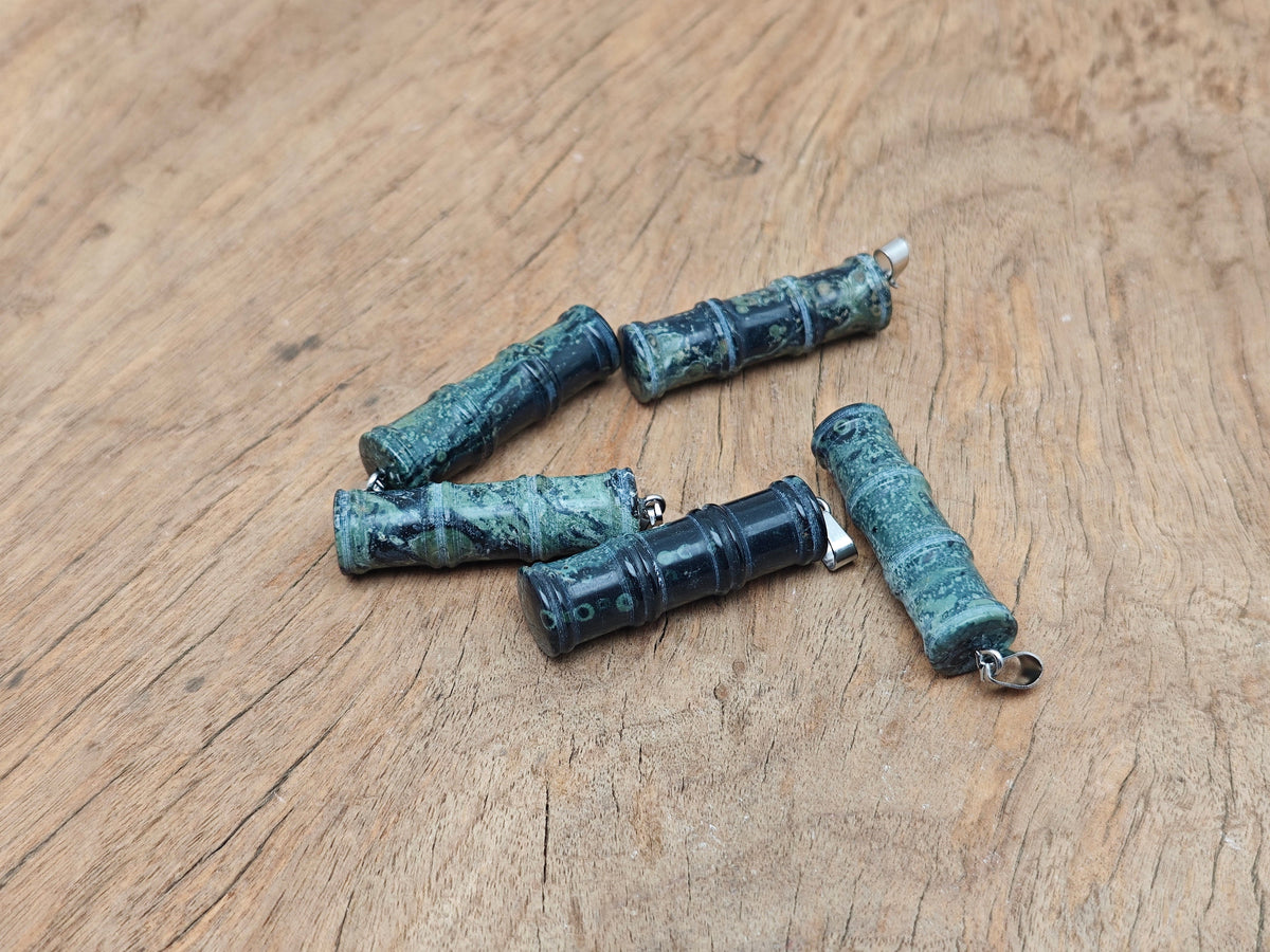 Kambaba Jasper bamboo-shaped crystal pendant from GemstoneGO, featuring a protective crystal design with green and black swirling patterns.