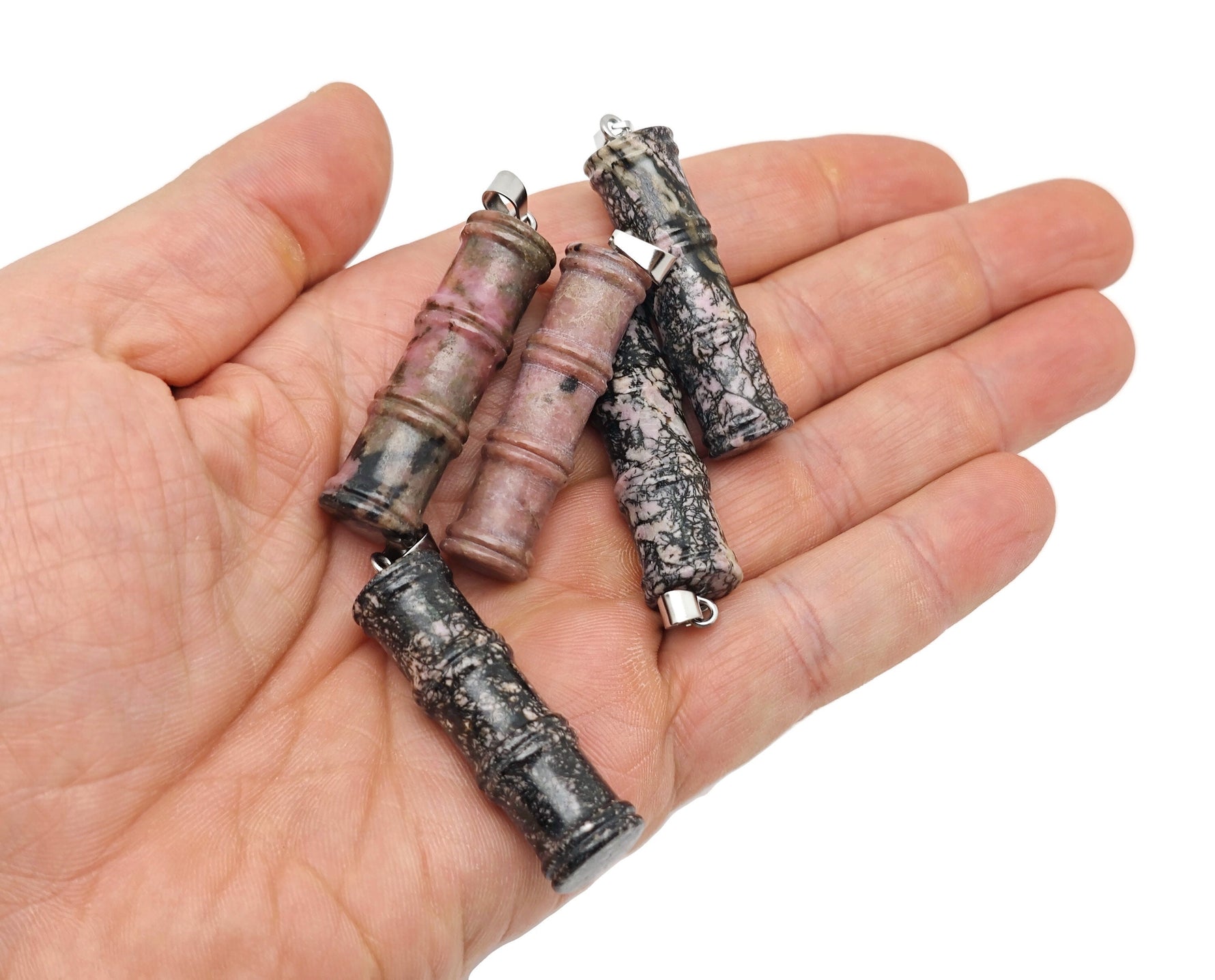 Rhodonite bamboo-shaped crystal pendant from GemstoneGO, featuring a protective, polished pink stone necklace accessory.