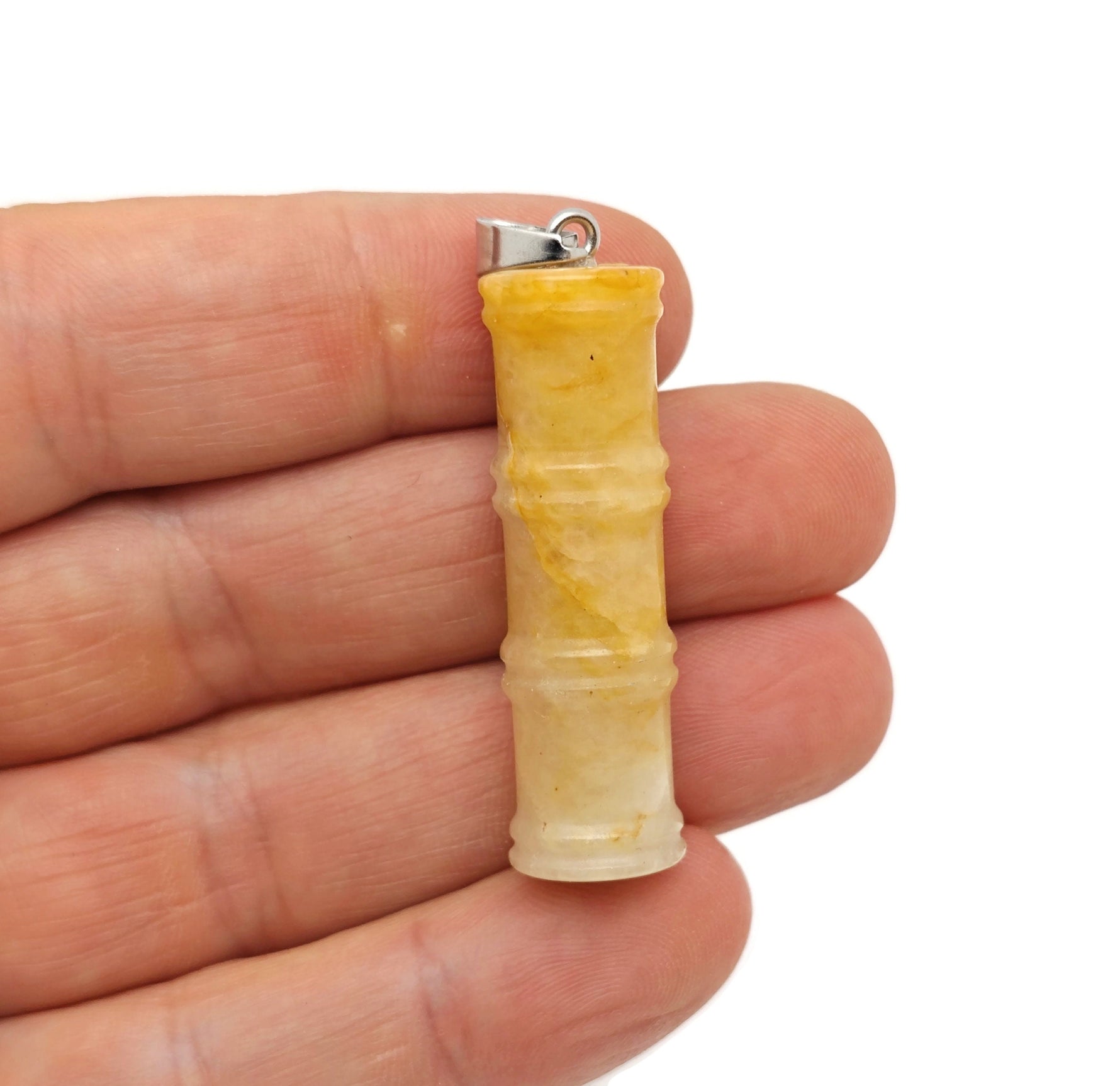 Yellow jade bamboo-shaped crystal pendant from GemstoneGO featuring a protective crystal design, perfect for jewelry or accessories.