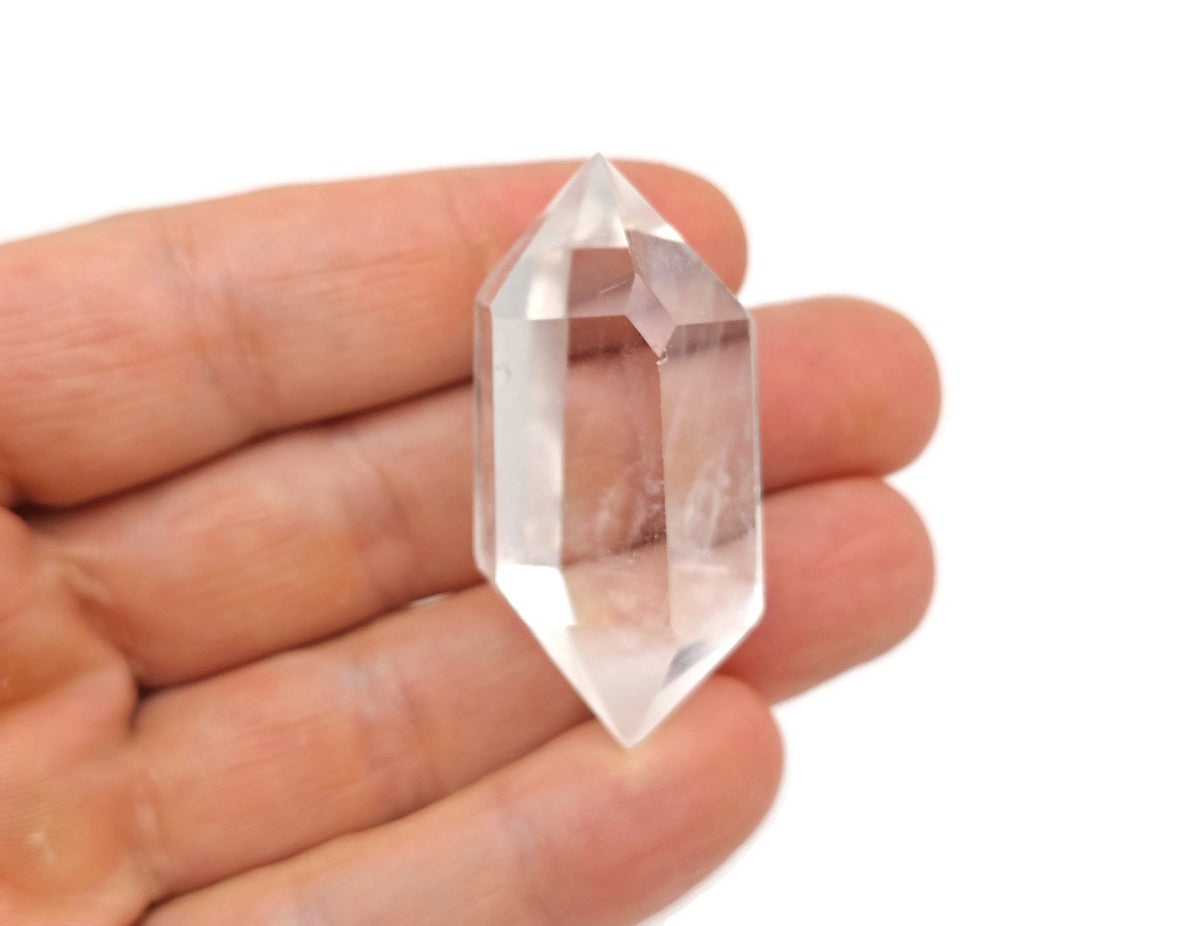 Clear quartz double obelisk tower crystal from GemstoneGO, showcasing a transparent, polished quartz crystal with a pointed top.