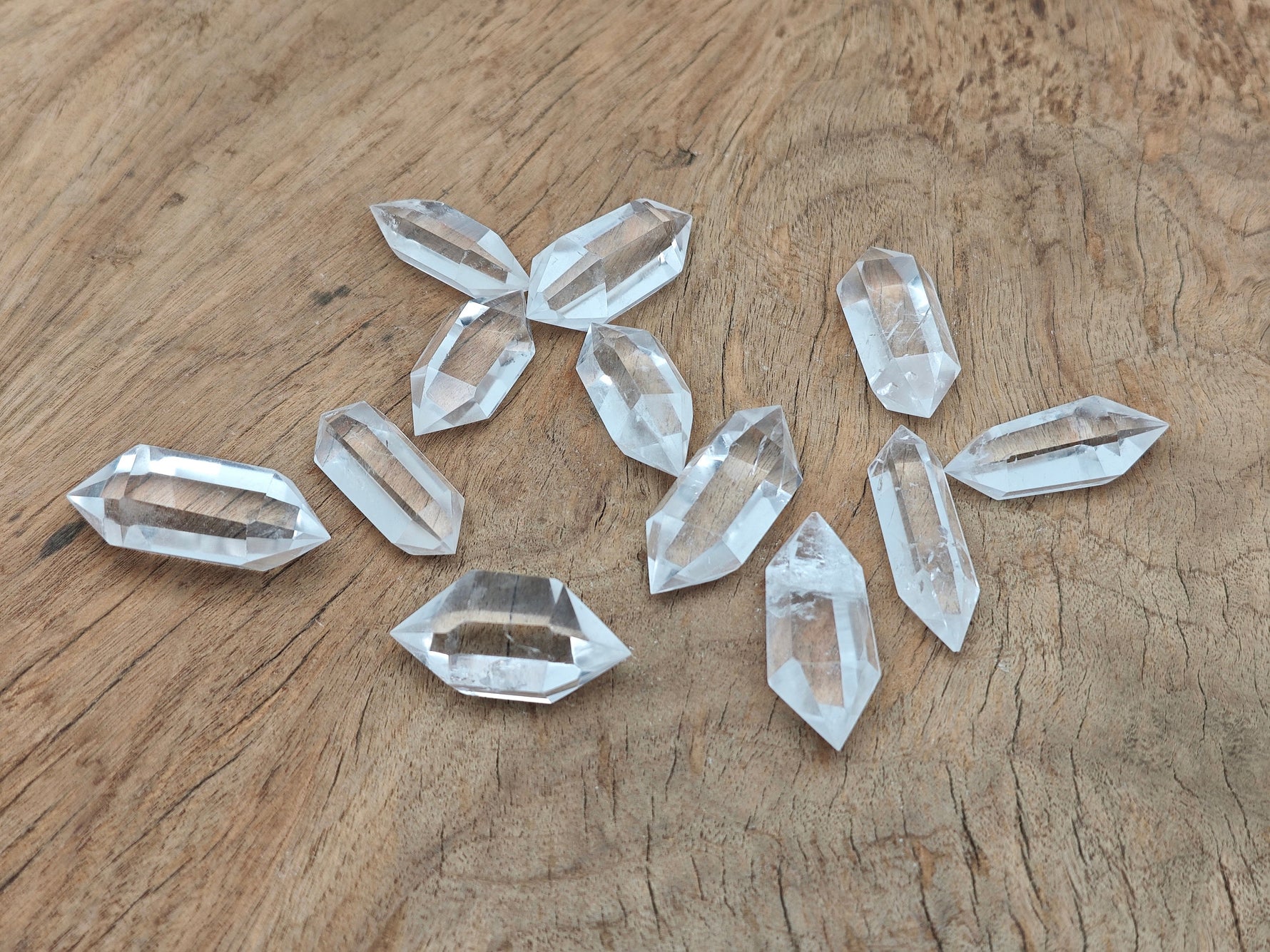 Clear Quartz double obelisk crystal tower by GemstoneGO, showing a polished transparent gemstone with natural facets and pointed tips.