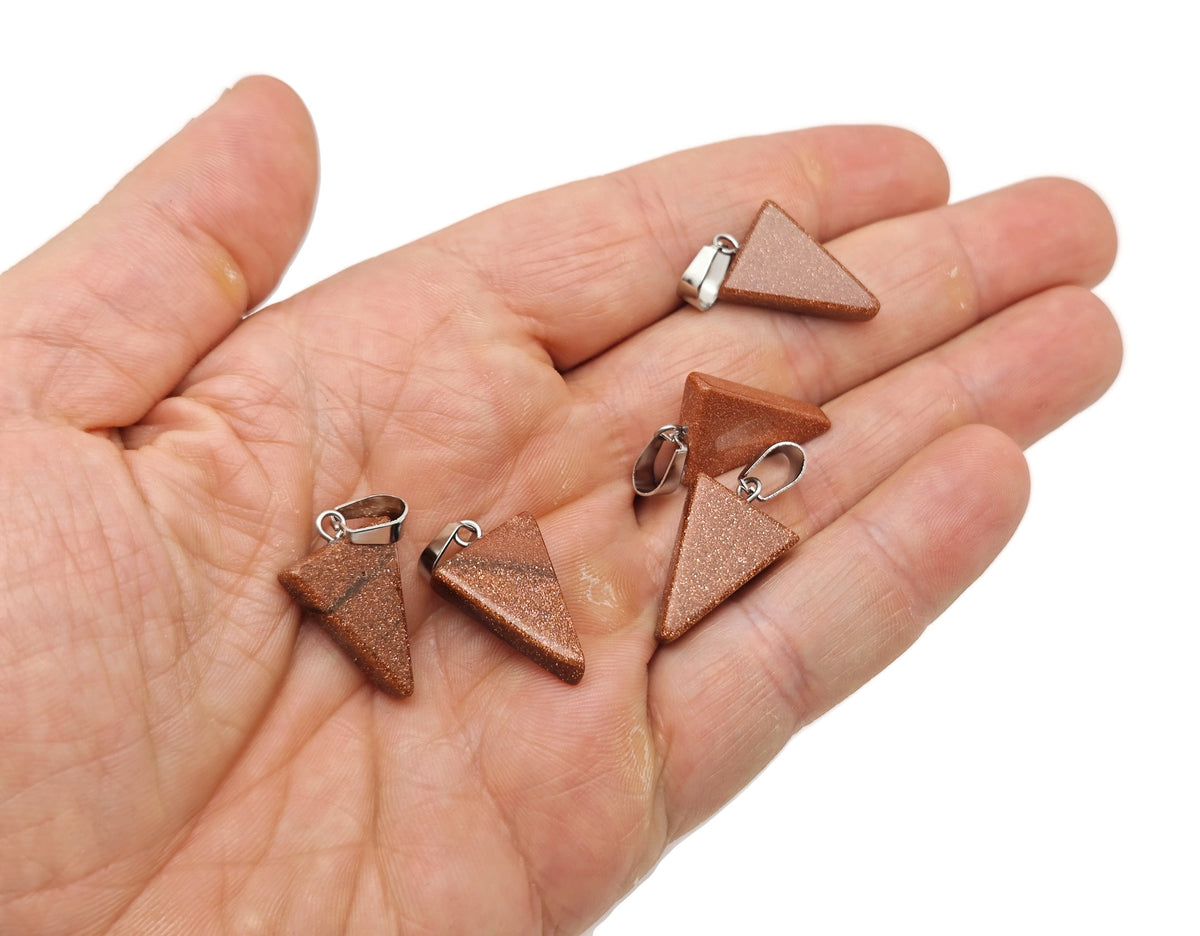 Triangle-shaped crystal pendant from GemstoneGO, ideal for jewelry making, shown in a bulk wholesale assortment.