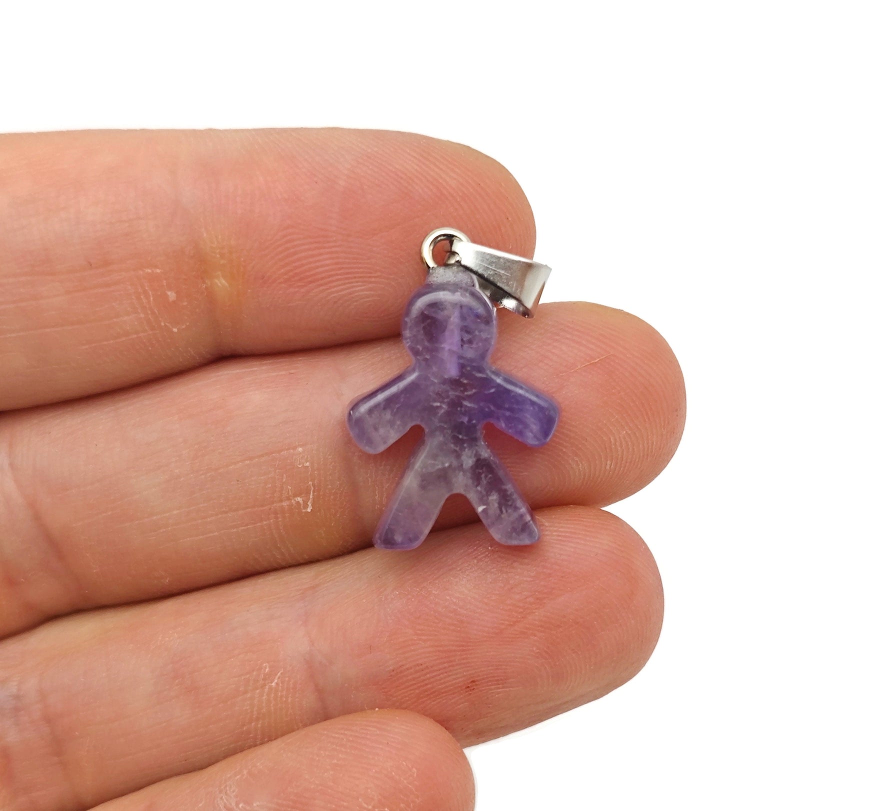 Amethyst gingerbread-shaped crystal pendant with a decorative mineral specimen design, featuring a silver bail for jewelry.