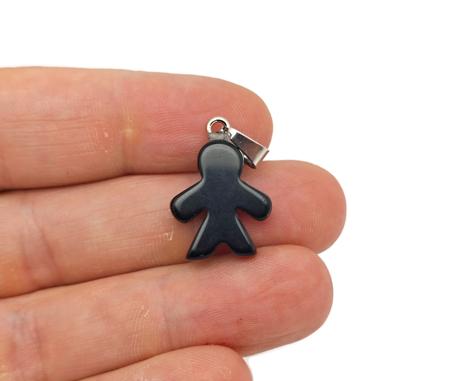 Obsidian gingerbread cookie men crystal pendant from GemstoneGO, featuring detailed mineral specimen design on a silver setting.