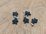 Obsidian gingerbread cookie men crystal pendant from GemstoneGO, featuring detailed mineral specimen design and a sleek black finish.