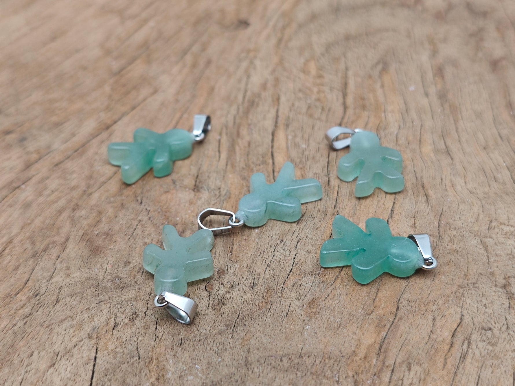Aventurine gingerbread cookie-shaped crystal pendant featuring a detailed gingerbread man design, crafted by GemstoneGO.