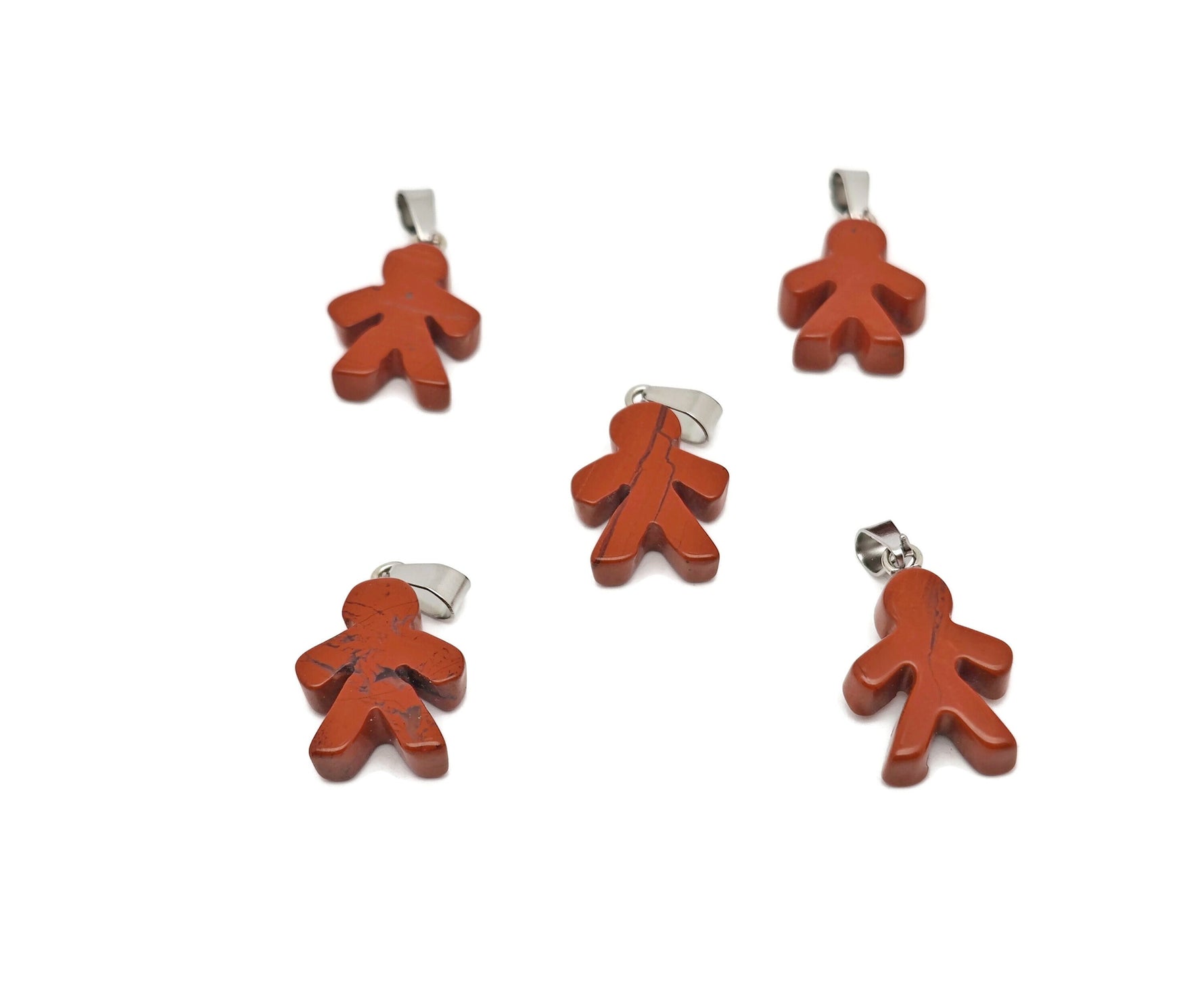 Red Jasper Gingerbread Cookies Men crystal pendant from GemstoneGO featuring detailed gingerbread men design and vibrant red jasper stone.