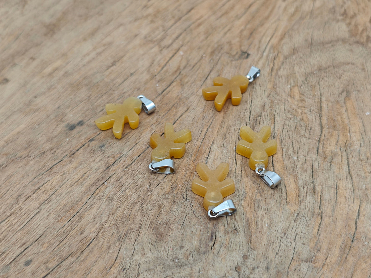 Yellow jade gingerbread men crystal pendant from GemstoneGO featuring a detailed mineral specimen with a festive gingerbread shape.