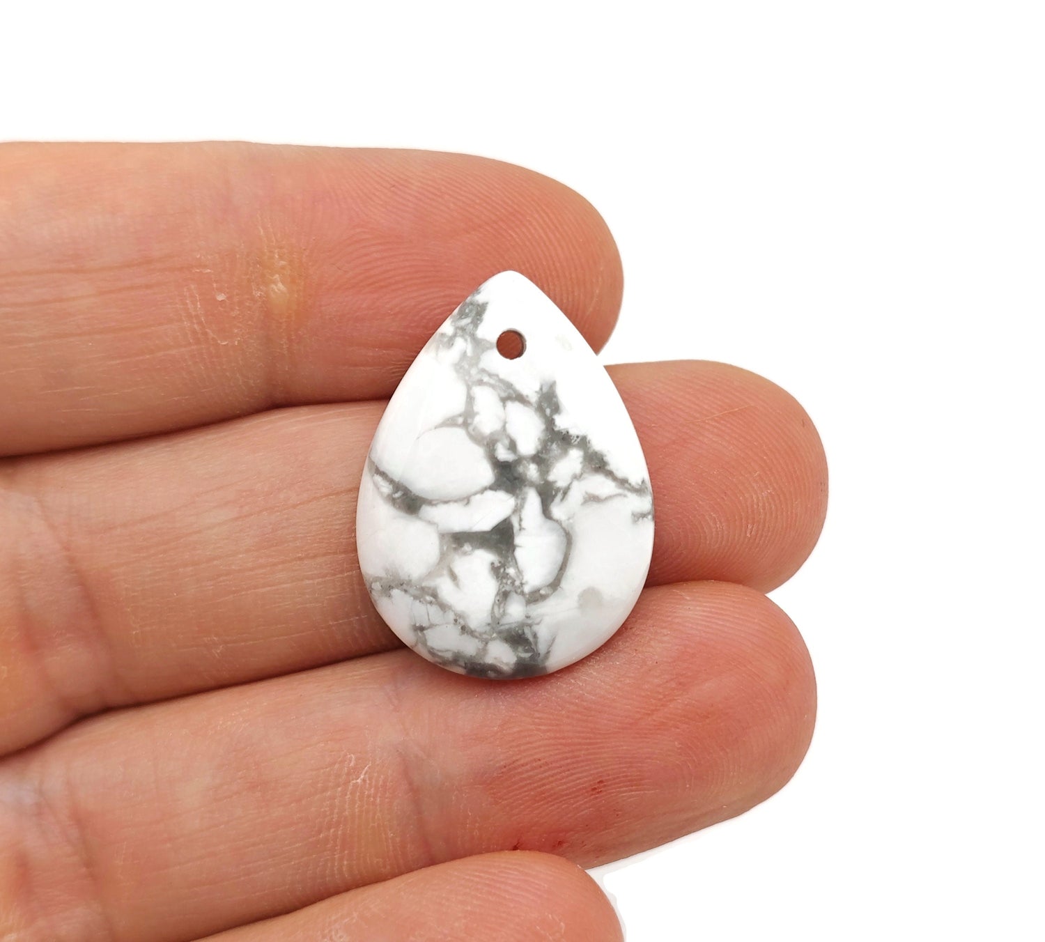Dainty Howlite drop crystal pendant for DIY jewelry making, showcasing smooth white stone with subtle gray veining, from GemstoneGO.