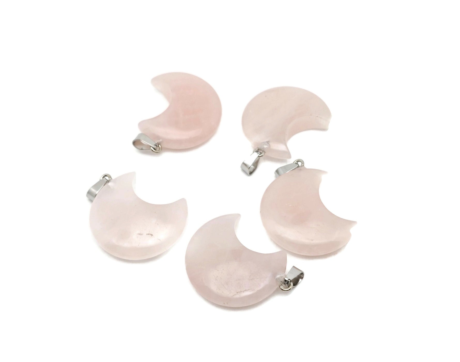 Pink rose quartz gemstone pendant in a crescent moon shape from GemstoneGO, highlighting its smooth polished surface and elegant design.