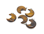 Tiger Eye moon gemstone pendant featuring a crescent moon design, crafted by GemstoneGO, showcasing warm, polished tiger eye stone.